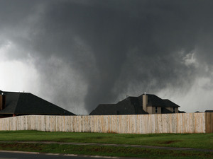A tornado moves past homes in Moore, Okla. on Monday.