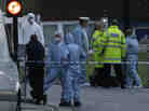Police and forensic officers near the scene of Wednesday's brutal attack.