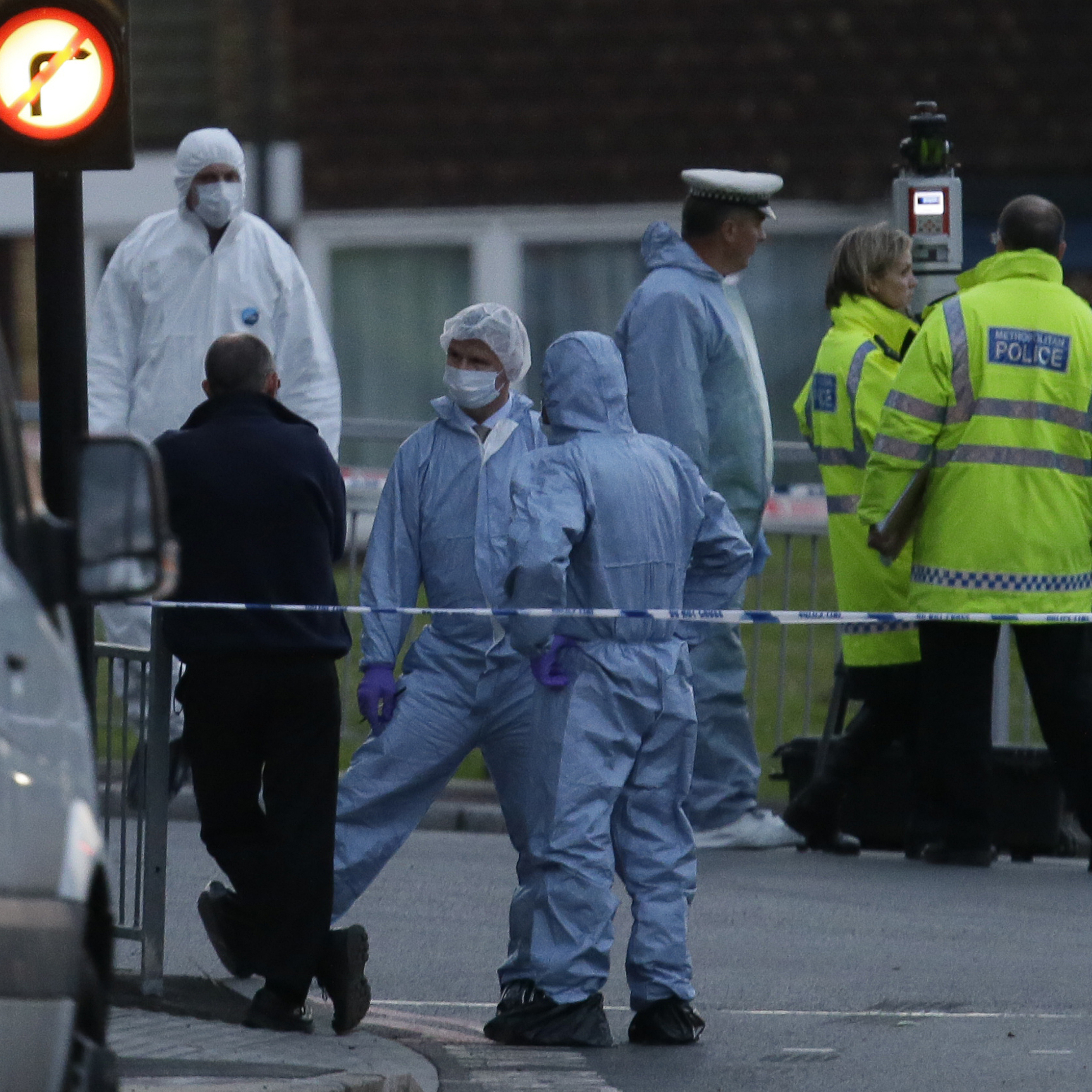 Police and forensic officers near the scene of Wednesday's brutal attack.