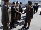 North Korea's Vice Marshal Choe Ryong Hae (front right) shakes hands with officials as he departs for China.