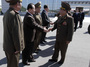 North Korean party and military official Choe Ryong Hae, (front right), shakes hands with as he departs for China.