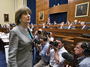 Lois Lerner, head of the IRS unit that decides whether to grant tax-exempt status to groups, leaves after being dismissed from a House Oversight and Government Reform Committee hearing on Wednesday.