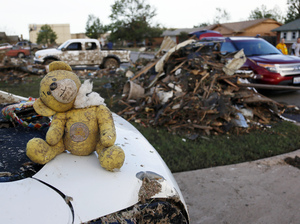A teddy bear sits atop some of the rubble in Moore, Okla.