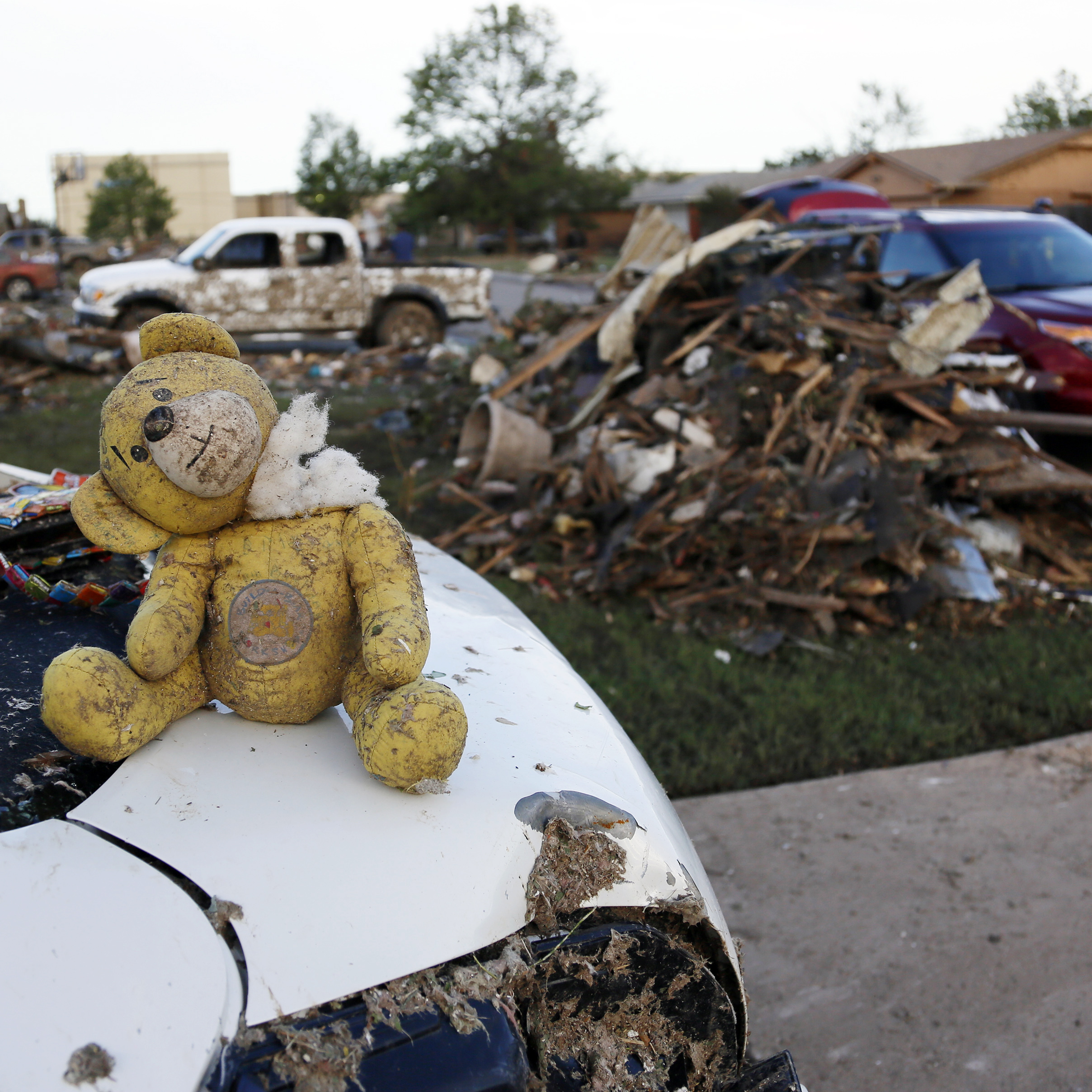 A teddy bear sits atop some of the rubble in Moore, Okla.