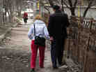 Oxana and Pavel Rucsineanu walk to the tuberculosis hospital in Balti, Moldova. Oxana and their new baby live in an apartment, but Pavel still has to stay at the TB ward, fighting for his life.