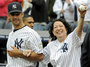 Sotomayor is escorted onto the field by New York Yankees catcher Jorge Posada to throw out the ceremonial first pitch before the New York Yankees game against the Boston Red Sox on Sept. 26, 2009 at Yankee Stadium in New York.