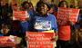 Protesters of Chicago Mayor Rahm Emmanuel's plan to close dozens of city schools rally in the Capitol rotunda in Springfield, Ill., on Wednesday. The Chicago Board of Education voted to close 50 schools.