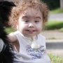 Kaiba Gionfriddo, who breathes with help from a splint created by a 3-D printer, plays with his family dog, Bandit, at his Youngstown, Ohio, home.