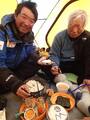 The world's highest sushi bar: On Tuesday, Yuichiro Miura, right, and his son made hand-wrapped sushi on the side of Mount Everest, at the fourth campsite during their climb to the top. The photo won many fans on Facebook.