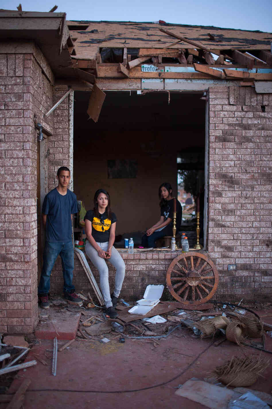 Siblings (from left) Alan, Sylvia and Ariel Trillo pose at their home in the Heather Wood subdivision in Moore. The Trillo home is one of the few homes there that is still standing, though everything inside is damaged. Siblings (from left) Alan, Sylvia and Ariel Trillo pose at their home in the Heather Wood subdivision in Moore. The Trillo home is one of the few homes there that is still standing, though everything inside is damaged.