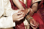 A bride and groom exchange rings during a traditional Indian wedding ceremony. Although most marriages in India are still arranged by parents, a growing number of women are taking matters of the heart into their own hands, using dating services and websites.