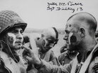 On June 5, 1944, Jake McNiece (right) led a group of paratroopers in World War II. After he shaved his head and painted his face before dropping behind German lines for D-Day, the look caught on with his men. On June 5, 1944, Jake McNiece (right) led a group of paratroopers in World War II. After he shaved his head and painted his face before dropping behind German lines for D-Day, the look caught on with his men.
