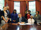 The Congressional Gold Medal has been posthumously awarded to four girls killed in the 1963 bombing of Birmingham's 16th Street Baptist Church. President Obama signed the legislation Friday, as (from left) Birmingham Mayor William Bell, Dr. Sharon Malone Holder, Attorney General Eric Holder, Rep. Terri Sewell, and relatives of Denise McNair and Carole Robertson look on. The Congressional Gold Medal has been posthumously awarded to four girls killed in the 1963 bombing of Birmingham's 16th Street Baptist Church. President Obama signed the legislation Friday, as (from left) Birmingham Mayor William Bell, Dr. Sharon Malone Holder, Attorney General Eric Holder, Rep. Terri Sewell, and relatives of Denise McNair and Carole Robertson look on.