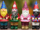 Decorated gnomes designed by celebrities, including Elton John (second from the right), are displayed at Chelsea Flower Show on Monday in London.