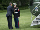 President Obama greets a Marine after forgetting to salute him while boarding Marine One on the South Lawn of the White House. President Obama greets a Marine after forgetting to salute him while boarding Marine One on the South Lawn of the White House.