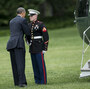 President Obama greets a Marine after forgetting to salute him while boarding Marine One on the South Lawn of the White House.