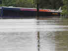 A San Antonio metro bus sits in floodwaters after it was swept off the road during heavy rains on Saturday.