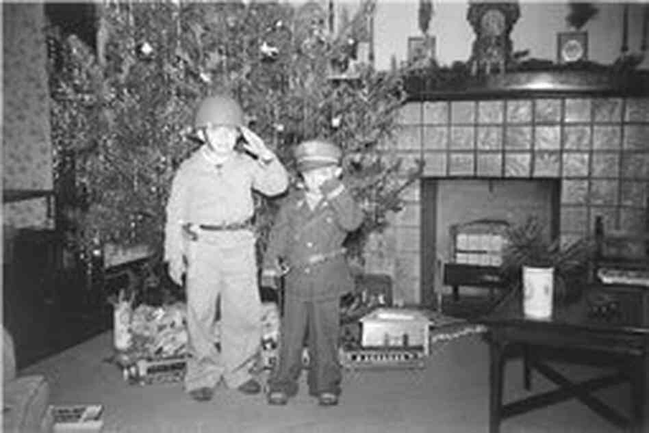 Walter Carter and his older brother salute their father, an Army doctor in World War II, in front of their Christmas tree in 1943. Walter Carter and his older brother salute their father, an Army doctor in World War II, in front of their Christmas tree in 1943.
