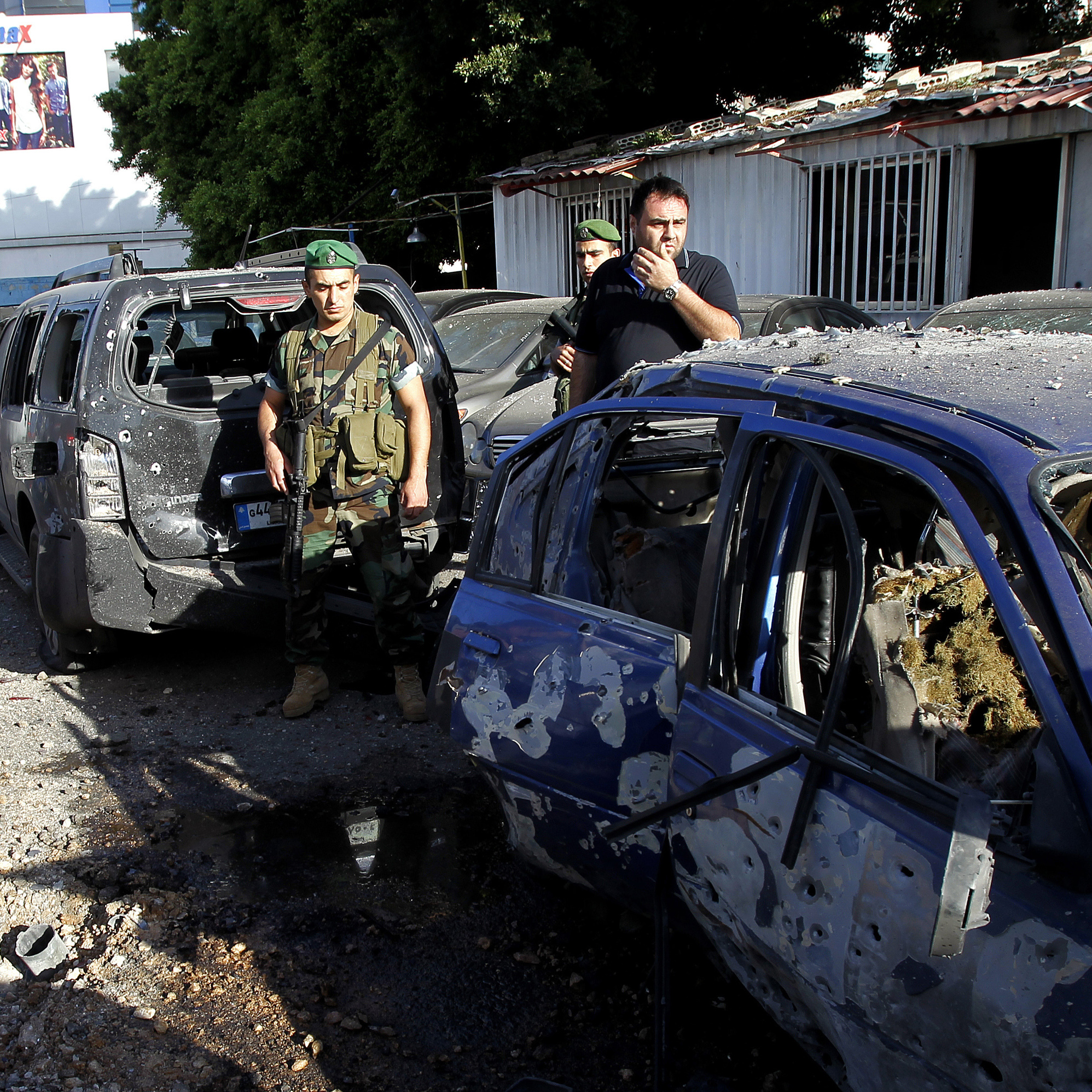 Lebanese security forces inspect the damage after two rockets exploded in Shiah, a southern suburb of Beirut, on Sunday.