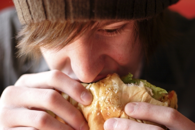 Teen boys are far less likely than girls to check out calorie counts before biting into that burger, researchers say.