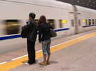 A couple waits for a high-speed train in the Chinese city of Qinhuangdao. Modern infrastructure and the expanding private sector have greatly increased efficiency and customer service in many parts of Chinese life. A couple waits for a high-speed train in the Chinese city of Qinhuangdao. Modern infrastructure and the expanding private sector have greatly increased efficiency and customer service in many parts of Chinese life.
