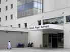 A nurse walks towards the Roger Salengro Hospital in Lille, France, where two patients were diagnosed with a coronavirus related to SARS.