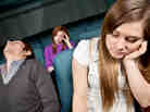 Bored people in a movie theater falling asleep.