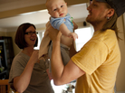 Dawn Heisey-Grove of Alexandria, Va., hands off son Zane to father Jonathan Heisey-Grove after a midday feeding. The couple were both working full time when Jonathan lost his job as a graphic designer two years ago. She's a public health analyst. He's now a stay-at-home dad. Dawn Heisey-Grove of Alexandria, Va., hands off son Zane to father Jonathan Heisey-Grove after a midday feeding. The couple were both working full time when Jonathan lost his job as a graphic designer two years ago. She's a public health analyst. He's now a stay-at-home dad.