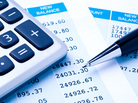 Close-up of a calculator, pen, and financial statement. Close-up of a calculator, pen, and financial statement.