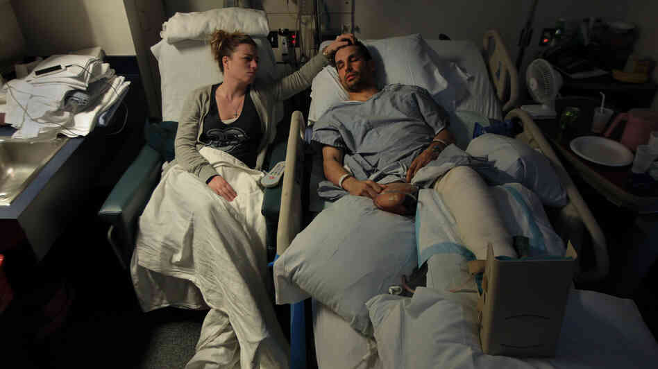 Jen Regan strokes the head of her fiancée, Marc Fucarile, as he sleeps in his hospital bed at Massachusetts General Hospital. Fucarile was injured in the bombings at the Boston Marathon, and had to have his right leg amputated. Jen Regan strokes the head of her fiancée, Marc Fucarile, as he sleeps in his hospital bed at Massachusetts General Hospital. Fucarile was injured in the bombings at the Boston Marathon, and had to have his right leg amputated.