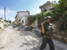 A Syrian soldier walks through the hotly contested city of Qusair on May 22. The Syrian army, backed by Lebanon's Hezbollah militia, has been waging a fierce fight with rebels in the key western city for the past two weeks. A Syrian soldier walks through the hotly contested city of Qusair on May 22. The Syrian army, backed by Lebanon's Hezbollah militia, has been waging a fierce fight with rebels in the key western city for the past two weeks.