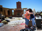 Tammy Wade (left) is hugged by Dana Givens in what is left of her home in El Reno, Okla., on Sunday, after it was destroyed by a tornado. Tammy Wade (left) is hugged by Dana Givens in what is left of her home in El Reno, Okla., on Sunday, after it was destroyed by a tornado.