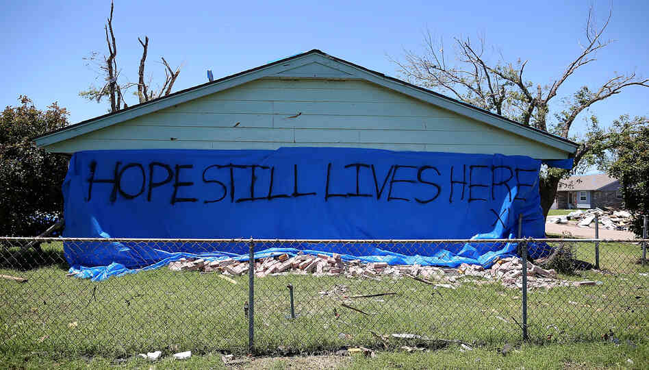 A sign proclaiming "Hope Still Lives Here" is posted on the side of a damaged home in Moore, Okla. A sign proclaiming "Hope Still Lives Here" is posted on the side of a damaged home in Moore, Okla.