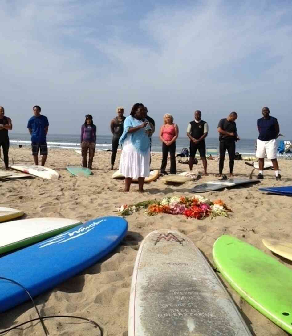 Surfers surround a celebrant who pours libations and says prayers to honor the spirit of surfers past and present and to give thanks to the sea for providing sustenance and recreation. Surfers surround a celebrant who pours libations and says prayers to honor the spirit of surfers past and present and to give thanks to the sea for providing sustenance and recreation.
