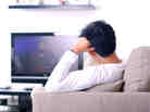 A guy watching television.