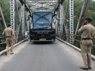 Indian police stop a tourist bus on Wednesday at a checkpoint put in place after the alleged rape of an American woman in the northern town of Manali. Indian police stop a tourist bus on Wednesday at a checkpoint put in place after the alleged rape of an American woman in the northern town of Manali.