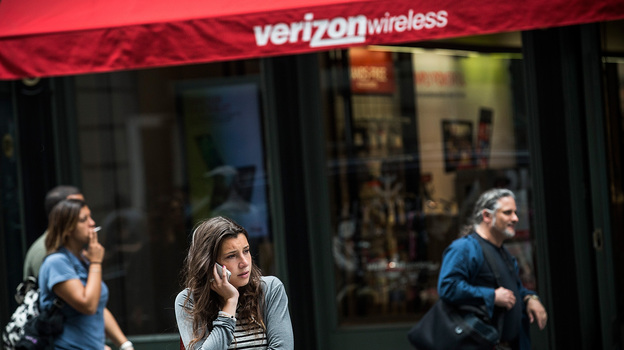 A woman uses her cellphone outside a Verizon Store in Manhattan on Thursday. (Getty Images)