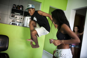 Costa practices passinho with Tais Castro, 14, in the Cidade de Deus neighborhood. Passinho incorporates more feminine and free movements, which were repressed by Rio's baile funk dance style.