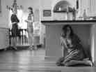 Amy Acker as Beatrice eavesdrops in a scene from Joss Whedon's new film version of Much Ado About Nothing.