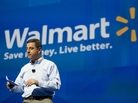 Wal-Mart U.S. CEO Bill Simon speaks to shareholders at Bud Walton Arena in Fayetteville, Ark., during this week's shareholders' meeting. The company is coping with a bribery scandal, as well as demands from workers. Wal-Mart U.S. CEO Bill Simon speaks to shareholders at Bud Walton Arena in Fayetteville, Ark., during this week's shareholders' meeting. The company is coping with a bribery scandal, as well as demands from workers.