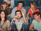 Man on the phone in a theater. Man on the phone in a theater.