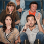 Man on the phone in a theater.