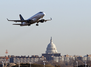 A jet takes off from Reagan National Airport, near the Capitol.