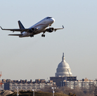 A jet takes off from Reagan National Airport, near the Capitol.
