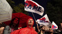 Protesters wave flags outside the Athens headquarters of broadcaster ERT on Wednesday. Prime Minister Antonis Samaras shut down the network Tuesday, but workers are occupying the building.