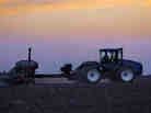 A central Illinois farmer plants corn seed into the evening in Farmingdale, Ill.