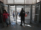 A U.S. Customs and Border Protection officer from the Office of Field Operations watches in February as people cross from Mexico into the United States at Nogales, Ariz. A U.S. Customs and Border Protection officer from the Office of Field Operations watches in February as people cross from Mexico into the United States at Nogales, Ariz.