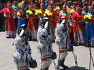 Chinese astronauts (from left) Wang Yaping, mission commander Nie Haisheng and Zhang Xiaoguang gesture as they prepare to board the Shenzhou-10 spacecraft in Jiuquan, China, on Tuesday. Chinese astronauts (from left) Wang Yaping, mission commander Nie Haisheng and Zhang Xiaoguang gesture as they prepare to board the Shenzhou-10 spacecraft in Jiuquan, China, on Tuesday.