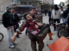 A man carries a boy badly wounded by the fighting between government forces and rebels on March 11, 2012. The U.N. says at least 93,000 people have been killed in the fighting. A man carries a boy badly wounded by the fighting between government forces and rebels on March 11, 2012. The U.N. says at least 93,000 people have been killed in the fighting.