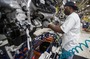 A worker installs parts on a Chrysler SUV engine at the Jefferson North Assembly Plant in Detroit. Plants in the U.S. are now operating above 90 percent capacity, but automakers are wary of adding large numbers of new workers.